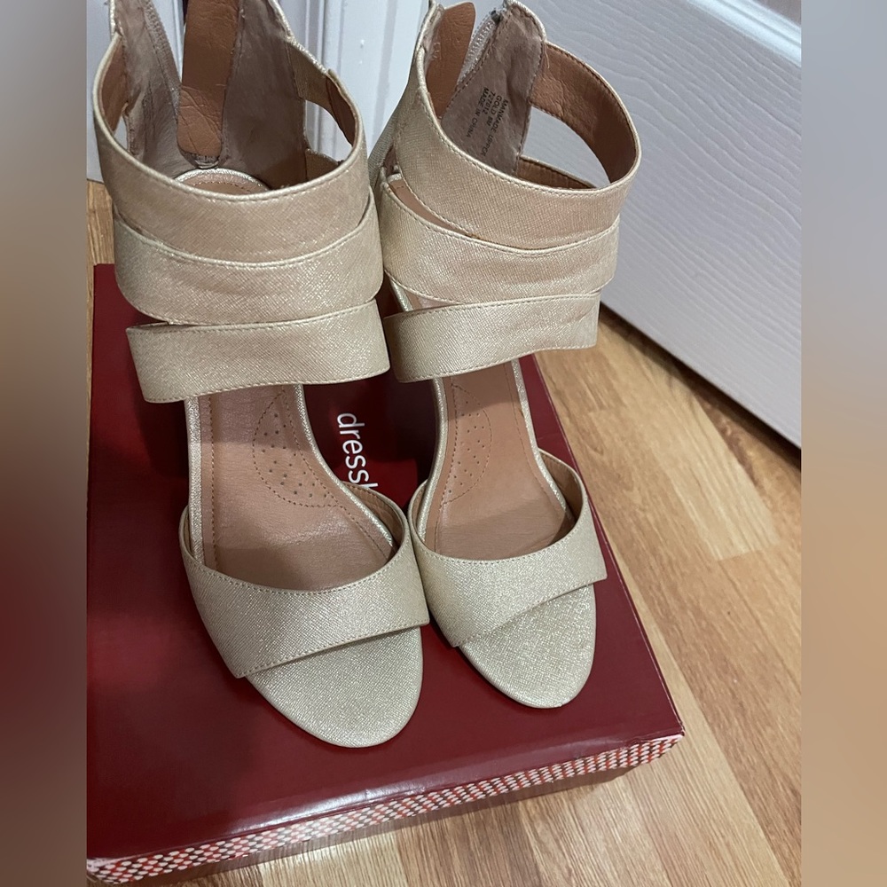 Open toed gold shimmer heels.